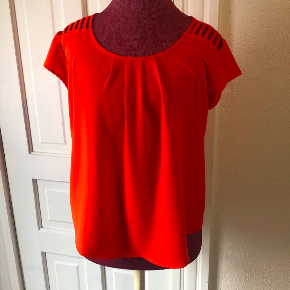 Red blouse with cut out shoulder design